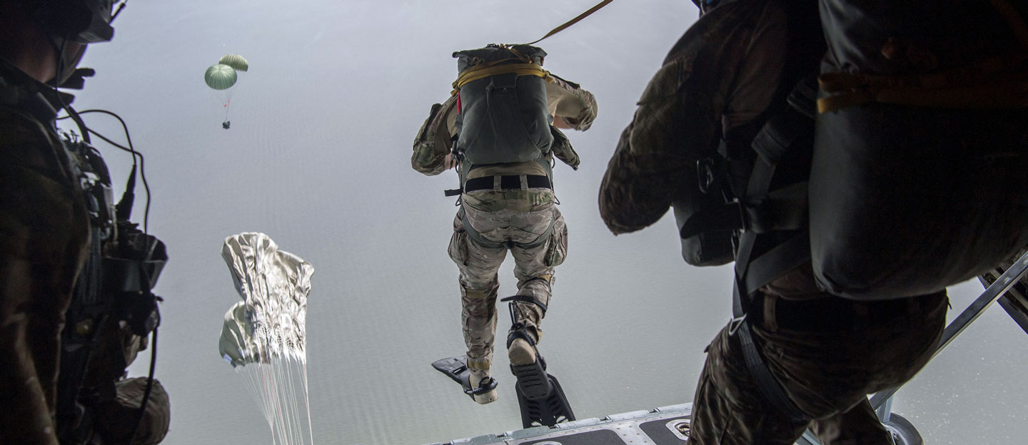 Pararescuemen gathering their equipment prior to flight